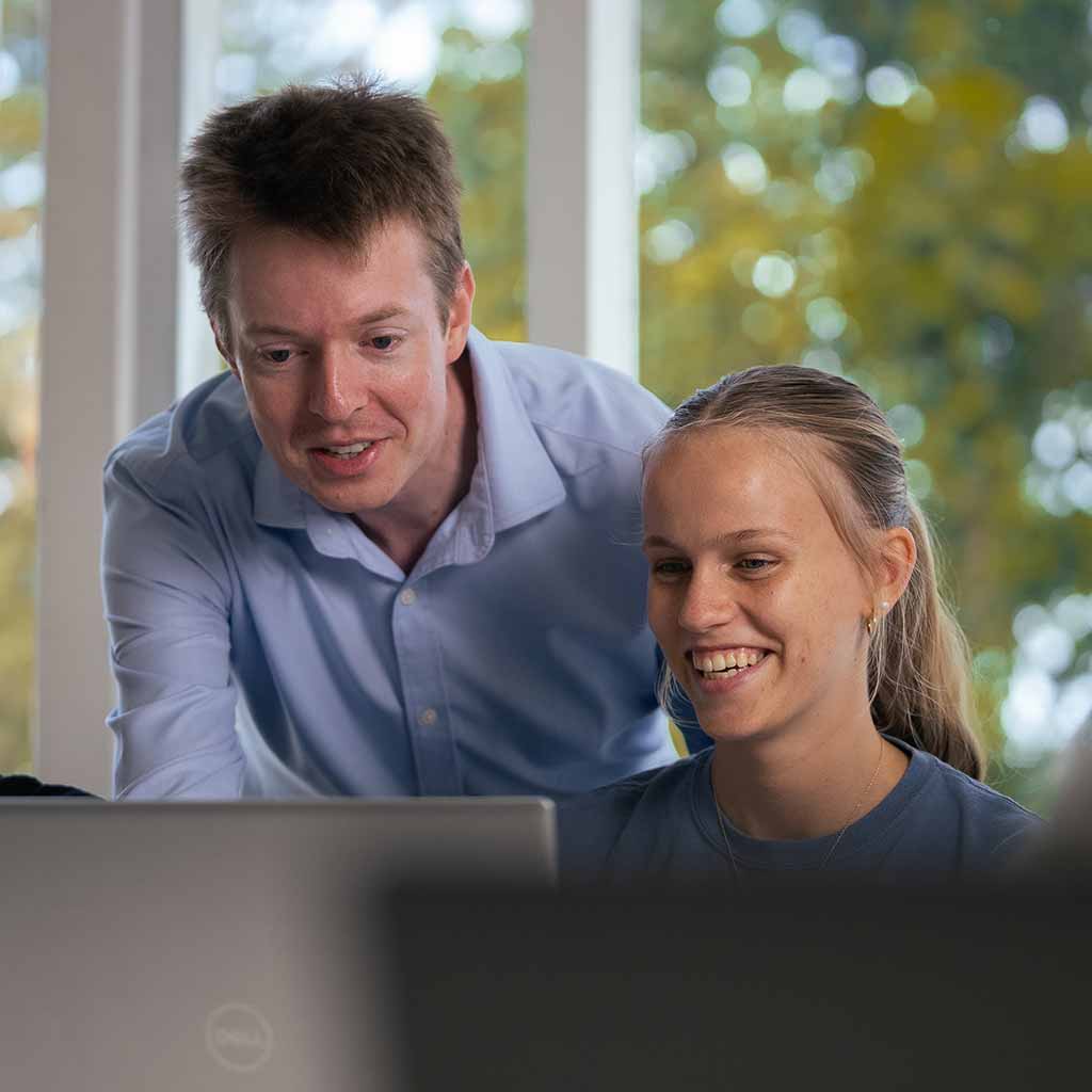Photo of a staff member assisting a student
